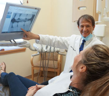 Dr. Blake reviewing x-ray with dental implant patient